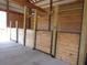 Interior of a barn with several horse stalls made of light-colored wood at 369 Groomsville Rd, Moncks Corner, SC 29461