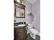 Small bathroom with dark vanity, toilet and decorative mirror at 369 Groomsville Rd, Moncks Corner, SC 29461