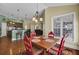 Bright breakfast nook with a rustic wooden table and red chairs at 369 Groomsville Rd, Moncks Corner, SC 29461