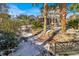 Landscaped backyard with palm trees and a stone retaining wall; snow on the ground at 5099 Ballantine Dr, Summerville, SC 29485