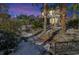 Landscaped backyard with a snow-covered ground and a bench; at dusk at 5099 Ballantine Dr, Summerville, SC 29485