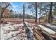 Peaceful backyard with snow-covered ground, trees, and a picnic table at 5099 Ballantine Dr, Summerville, SC 29485