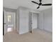 Bright bedroom with neutral walls and carpet at 5294 Seewee Rd, Awendaw, SC 29429