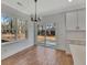 Bright dining room with hardwood floors and sliding glass doors to backyard at 5294 Seewee Rd, Awendaw, SC 29429