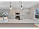 Modern kitchen with white cabinets, quartz countertops, and stainless steel appliances at 5294 Seewee Rd, Awendaw, SC 29429