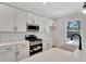 Modern kitchen with white cabinets, stainless steel appliances, and subway tile backsplash at 5294 Seewee Rd, Awendaw, SC 29429