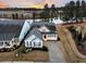 Two-story house with gray siding, white trim, and a two-car garage next to a pond at 559 Tidewater Chase Ln, Summerville, SC 29486