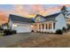 Gray siding two-story house, white porch, and a two-car garage at 559 Tidewater Chase Ln, Summerville, SC 29486