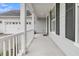 Front porch with white railing and gray siding at 559 Tidewater Chase Ln, Summerville, SC 29486