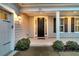 Front porch with white columns, black front door, and gray siding at 559 Tidewater Chase Ln, Summerville, SC 29486