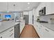 Modern kitchen with white cabinets, stainless steel appliances, and large island at 559 Tidewater Chase Ln, Summerville, SC 29486