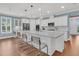 Modern kitchen with white cabinets, large island, and stainless steel appliances at 559 Tidewater Chase Ln, Summerville, SC 29486