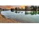 Serene lake view with reflections of trees and sky at sunset at 559 Tidewater Chase Ln, Summerville, SC 29486