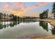 Calm lake reflecting the sunset sky and surrounding trees at 559 Tidewater Chase Ln, Summerville, SC 29486