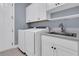 Laundry room with white cabinets and a utility sink at 559 Tidewater Chase Ln, Summerville, SC 29486