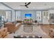 Relaxing living room featuring a leather couch and a large TV at 559 Tidewater Chase Ln, Summerville, SC 29486