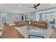 Open living room with leather sofas and access to sunroom and dining area at 559 Tidewater Chase Ln, Summerville, SC 29486