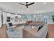 Spacious living room with a brown leather sectional sofa and large windows at 559 Tidewater Chase Ln, Summerville, SC 29486
