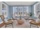 Bright sunroom with wicker chairs and large windows overlooking the backyard at 559 Tidewater Chase Ln, Summerville, SC 29486
