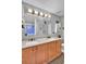 Modern bathroom with double sinks, light wood cabinets, and a gray backsplash at 588 Delafield Dr, Summerville, SC 29483