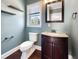 Elegant bathroom with dark vanity, granite countertop, and a window at 7228 Mossy Creek Ln, Hanahan, SC 29410