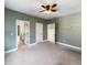 Bedroom with green walls, carpet, and access to two rooms at 7228 Mossy Creek Ln, Hanahan, SC 29410