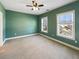 Bedroom with green walls, neutral carpet, and two windows at 7228 Mossy Creek Ln, Hanahan, SC 29410