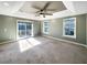 Main bedroom with sliding glass doors leading to a deck and plush carpeting at 7228 Mossy Creek Ln, Hanahan, SC 29410
