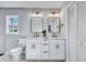 Double vanity bathroom with white cabinets and gold accents at 1 Hunters Forest Dr, Charleston, SC 29414