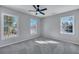 Bright bedroom with gray carpeting, ceiling fan, and large windows at 1 Hunters Forest Dr, Charleston, SC 29414