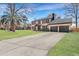 Two-story brick home with black accents and a large driveway at 1 Hunters Forest Dr, Charleston, SC 29414