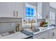 Modern kitchen with white cabinets, quartz countertops, and a stylish gold faucet at 1 Hunters Forest Dr, Charleston, SC 29414
