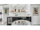 Modern basement bar with marble backsplash and mini fridge at 100 Murray Blvd, Charleston, SC 29401