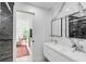 Modern bathroom with double vanity, marble tile and a walk-in shower at 100 Murray Blvd, Charleston, SC 29401