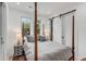 Bright bedroom with a four-poster bed and sliding barn door at 100 Murray Blvd, Charleston, SC 29401