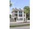 Modern three-story house with black windows and fence; street view at 100 Murray Blvd, Charleston, SC 29401