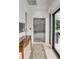 Bright hallway with home elevator and access to patio at 100 Murray Blvd, Charleston, SC 29401