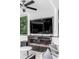 Modern outdoor fireplace with a large TV and comfortable seating at 100 Murray Blvd, Charleston, SC 29401