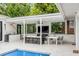 Covered patio features a dining area and comfortable seating near the pool at 100 Murray Blvd, Charleston, SC 29401