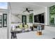 Relaxing patio with a fireplace, comfortable seating, and a large TV at 100 Murray Blvd, Charleston, SC 29401