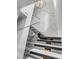 Modern glass and metal staircase with marble wall at 100 Murray Blvd, Charleston, SC 29401