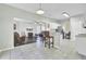 Open concept kitchen with breakfast bar and view into the living room at 100 Remington Dr, North Charleston, SC 29418