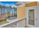 Private balcony with white railing, offering a view of trees and parking at 1034 Rosewood Ln, Mount Pleasant, SC 29464