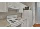 White kitchen with stove, refrigerator and ample counter space at 1034 Rosewood Ln, Mount Pleasant, SC 29464