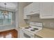 White stove and range, microwave, and overhead cabinets at 1034 Rosewood Ln, Mount Pleasant, SC 29464