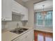 White kitchen cabinets, double sink, and view to dining area at 1034 Rosewood Ln, Mount Pleasant, SC 29464