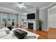 Virtually staged living room with fireplace and hardwood floors at 1034 Rosewood Ln, Mount Pleasant, SC 29464