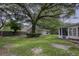 Large backyard with mature trees and detached garage at 1134 Mim Ave, Charleston, SC 29407