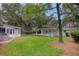Large backyard with mature trees and detached garage at 1134 Mim Ave, Charleston, SC 29407