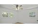 Bright bedroom with hardwood floors, ceiling fan, and two windows at 1134 Mim Ave, Charleston, SC 29407